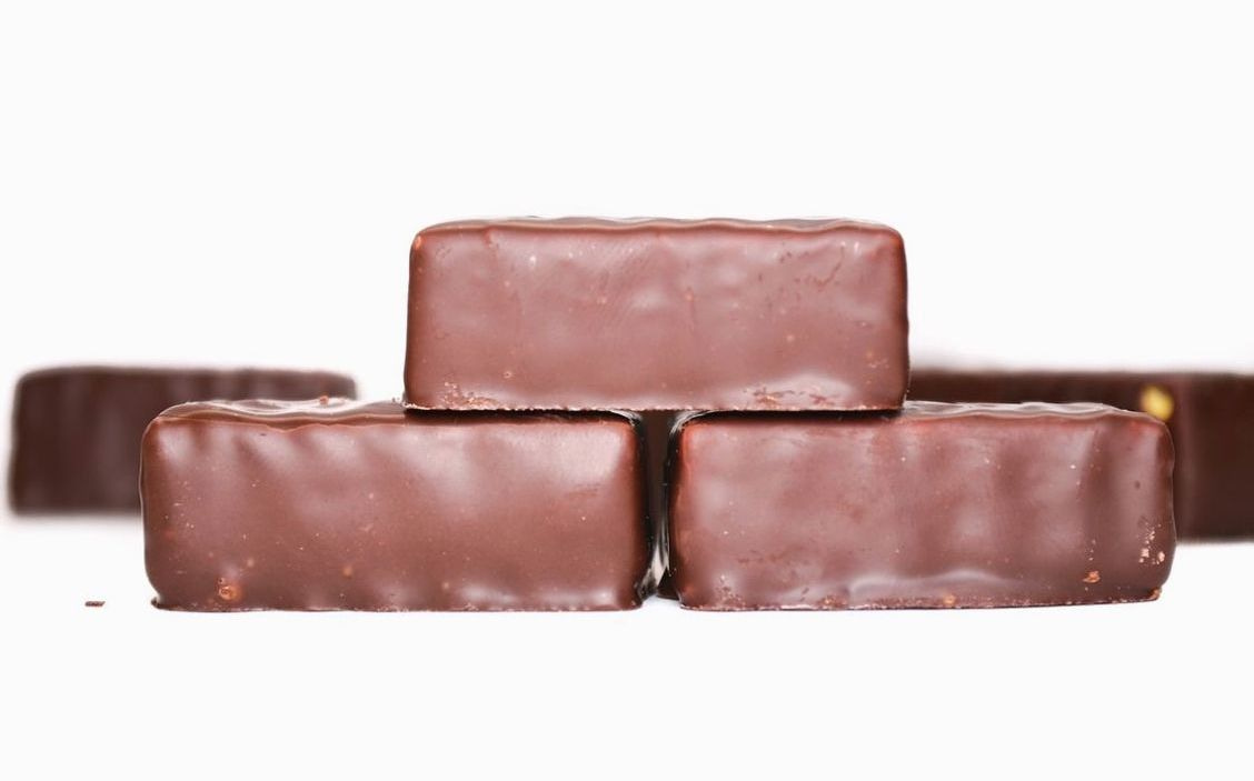 A salted caramel bonbon with glossy chocolate coating